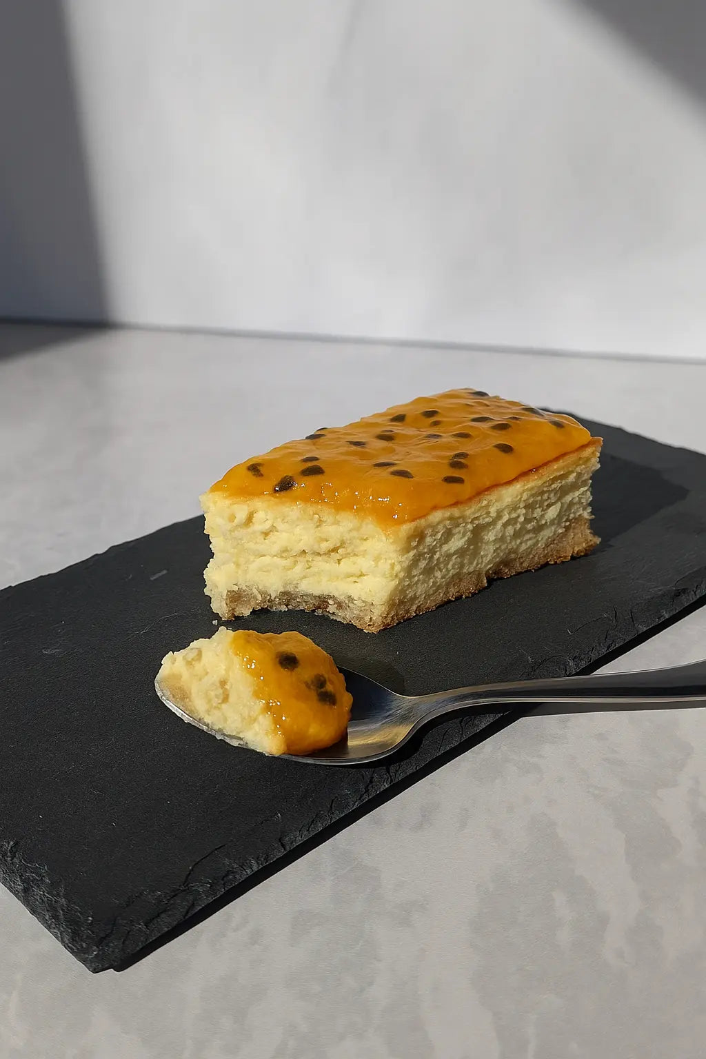 Cheesecake keto premium con base de almendras y opciones de topping: maracuyá, manjar o berries.